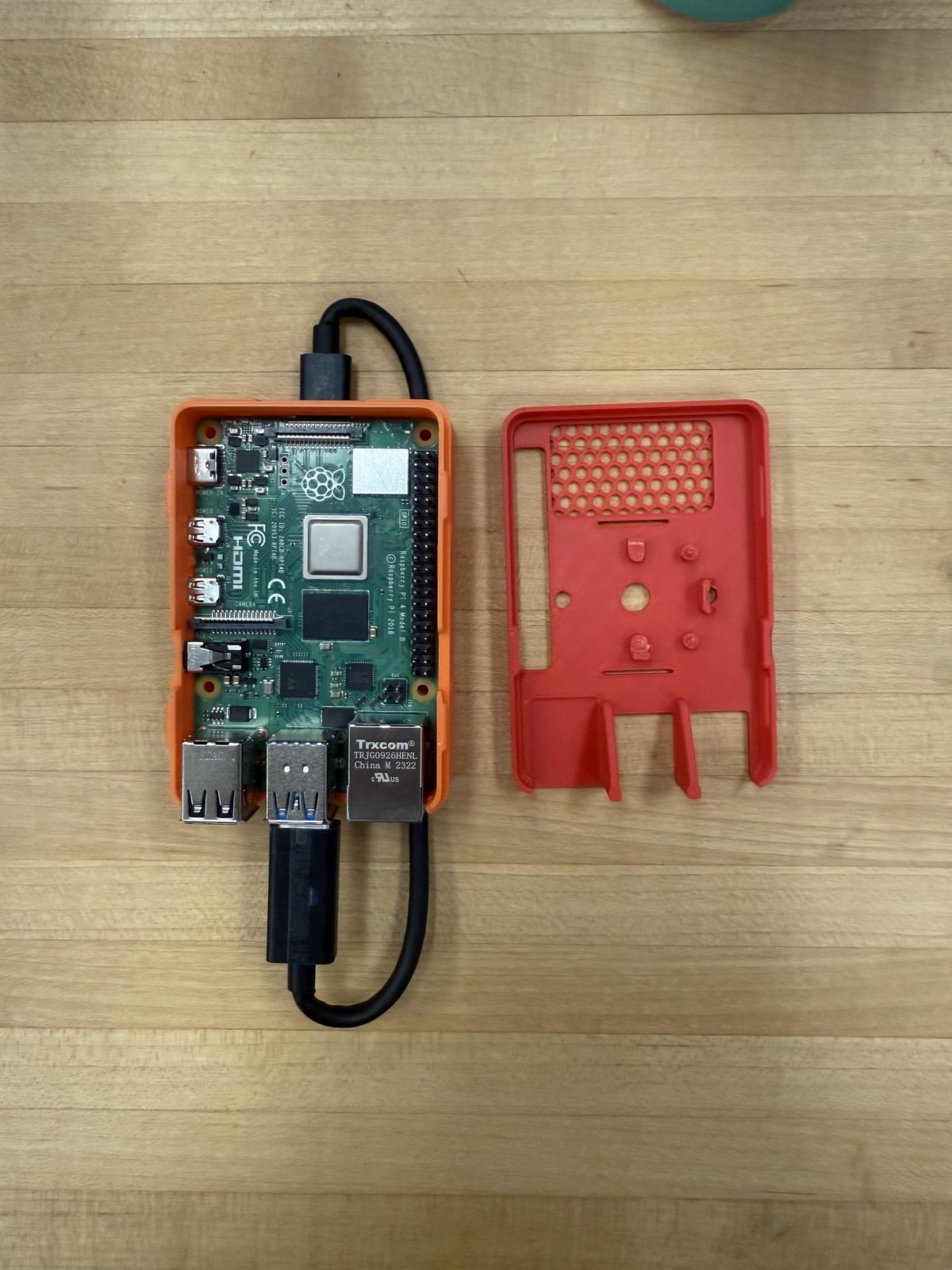 Single-board computer beside its 3D-printed enclosure